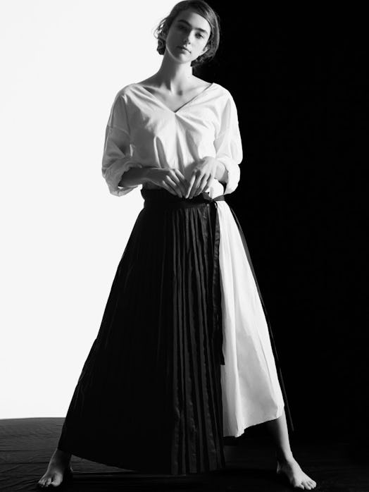 A model posing in a black-and-white dress by Chinese fashion designer, Marchen.