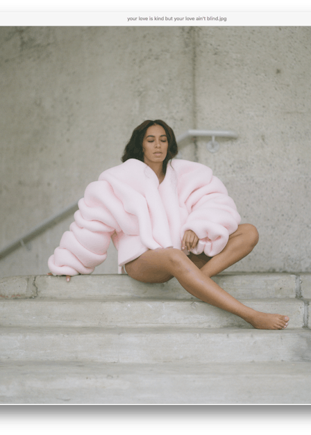 Solange sitting at a top of stairs