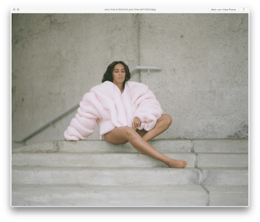 Solange sitting on stairs in a baby pink puffer jacket 