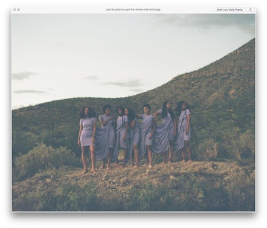 Solange and the girls standing on top of a hill while posing in lavender dresses 