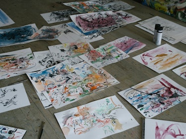 Cecily Brown's paintings laid out on the floor in her New York studio