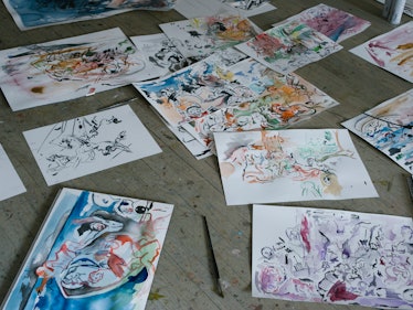 Cecily Brown's paintings laid out on the floor in her New York studio