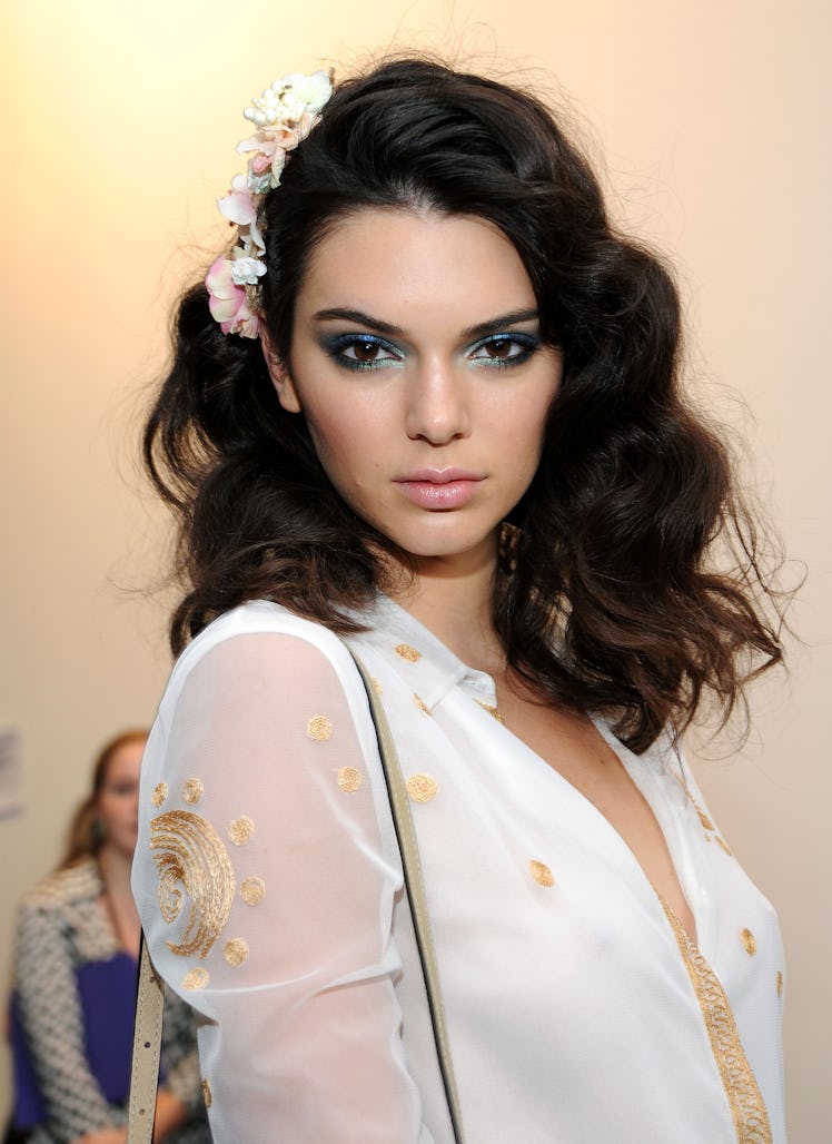 Kendall Jenner, with large soft curls and a bold, colorful eye at the Diane Von Furstenberg Spring 2...