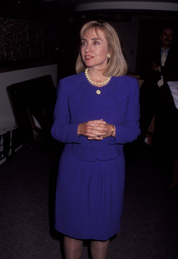 Hillary Clinton wearing a blue blazer, a skirt, and a pearl necklace in 1992
