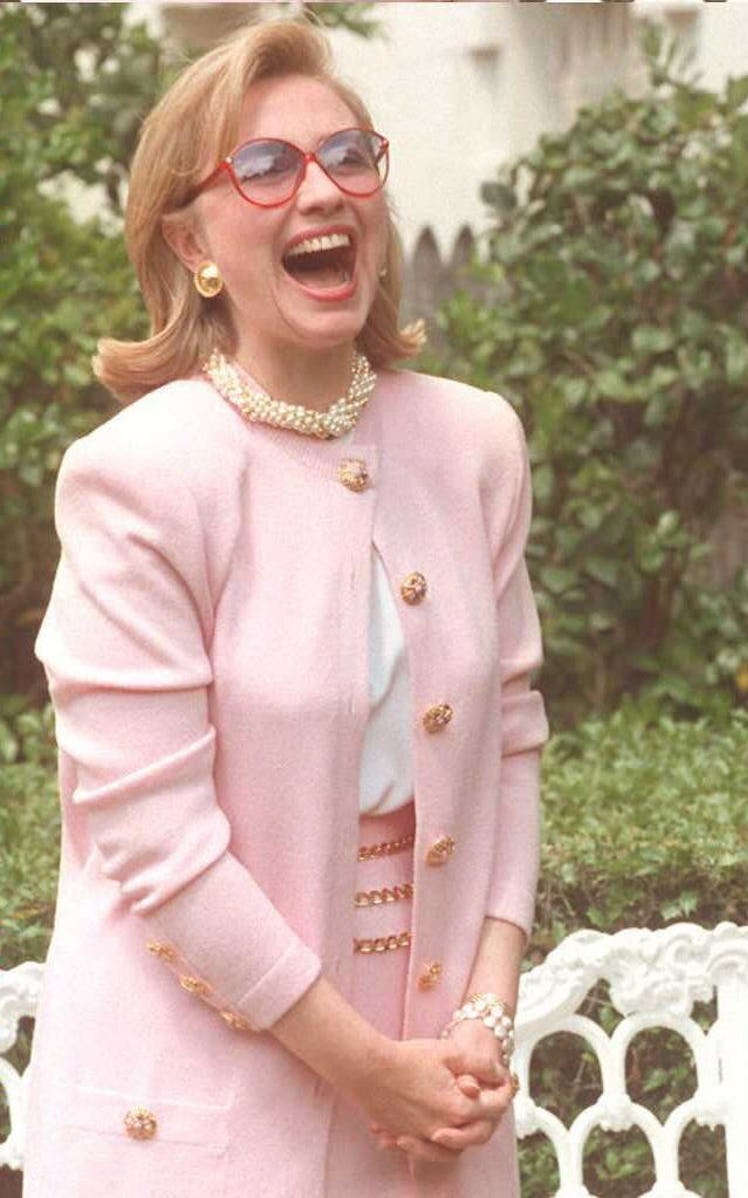 Hillary Clinton in a pink blazer and skirt and a white shirt with a pearl necklace in January 1993