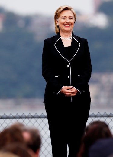 Hillary Clinton in a black blazer and trousers with white details in September 2009