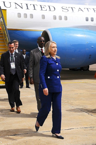 Hillary Clinton leaving an airplane in a blue blazer and trousers in August 2012