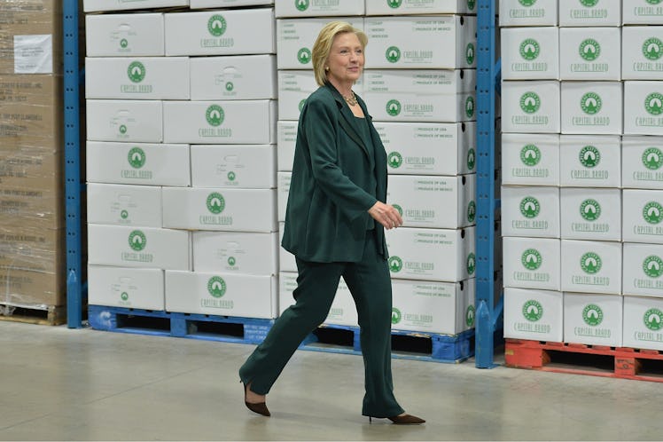 Hillary Clinton walking in an emerald suit and black pumps in April 2015
