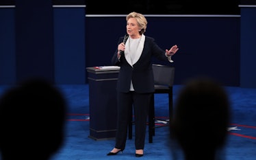 Hillary Clinton giving a speech in a black-white blazer and black trousers in September 2016 while g...