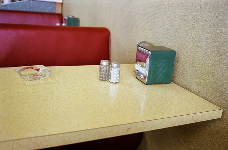 A table with an ashtray, salt, pepper, and tissues