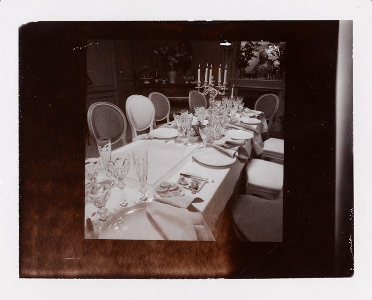 Miles Aldridge's polaroid featuring a decorated dining table and chairs around it