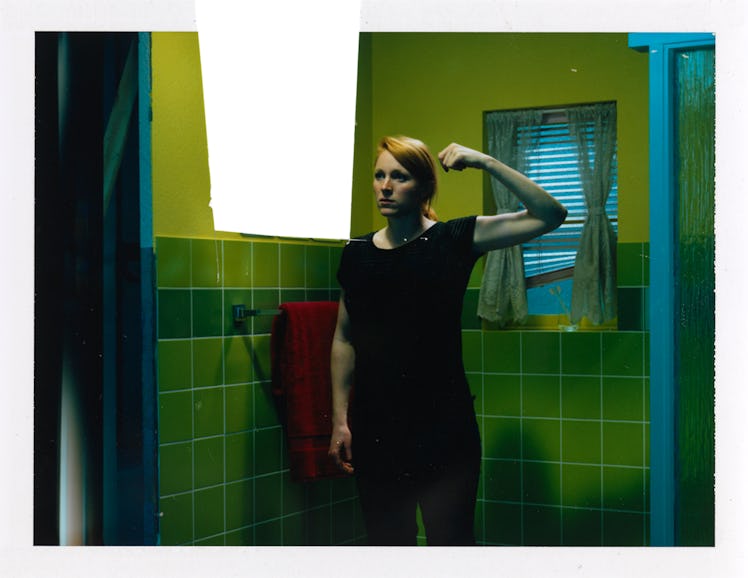 Miles Aldridge's polaroid featuring a ginger woman with one arm raised and showing off her biceps in...