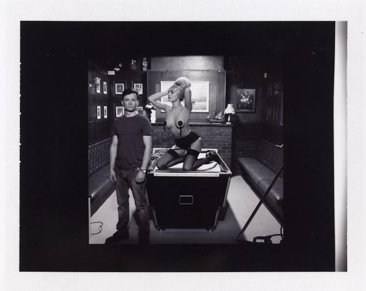 Miles Aldridge's polaroid featuring a man standing next to a billiard table with a semi-naked woman ...
