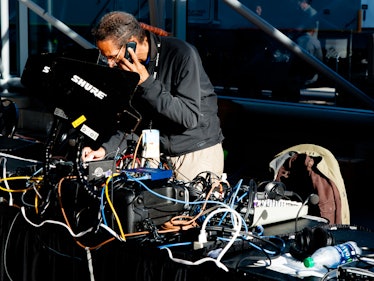 A man talking on his phone while checking the sound system during Hillary Clinton's election night p...