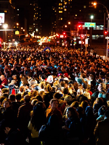 A large crowd of people gathered in front of the Jacob K. Javits Convention Center waiting for the e...
