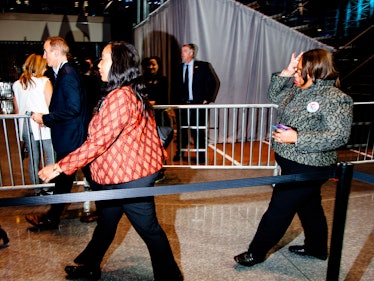Two women entering the Jacob K. Javits Convention Center wearing blazers 