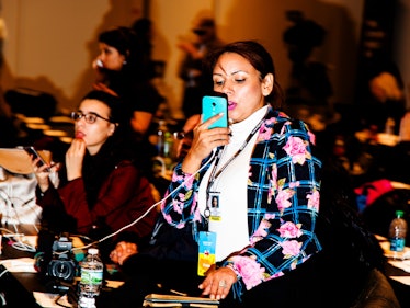 A woman taking a video with her phone at the Jacob K. Javits Convention Center during the election n...