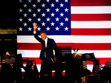 A man speaking at Hillary Clinton's election night rally with the American flag behind him and a cro...