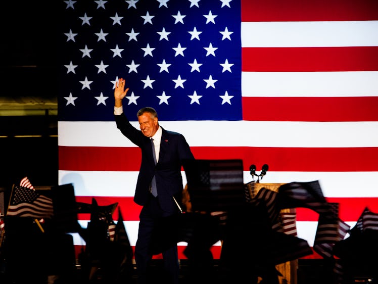 A man speaking at Hillary Clinton's election night rally with the American flag behind him and a cro...