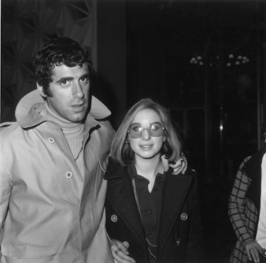 Barbra Streisand in a jacket and sunglasses and Elliott Gould in a jacket in 1968
