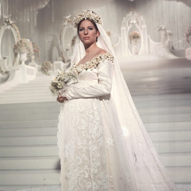 Streisand standing on stairs in a wedding dress, starring as a bride in “Funny Girl” 