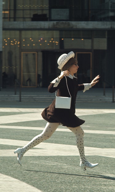 Streisand wearing polka dot panty leggings, a polka dot hat, and a double button coat with a polka d...