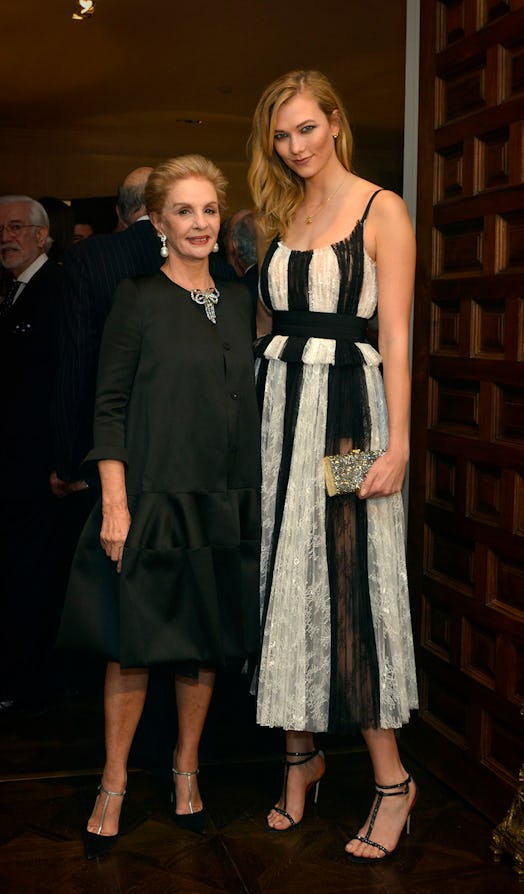 Carolina Herrera in a black dress and Karlie Kloss in a white-black striped dress in Madrid