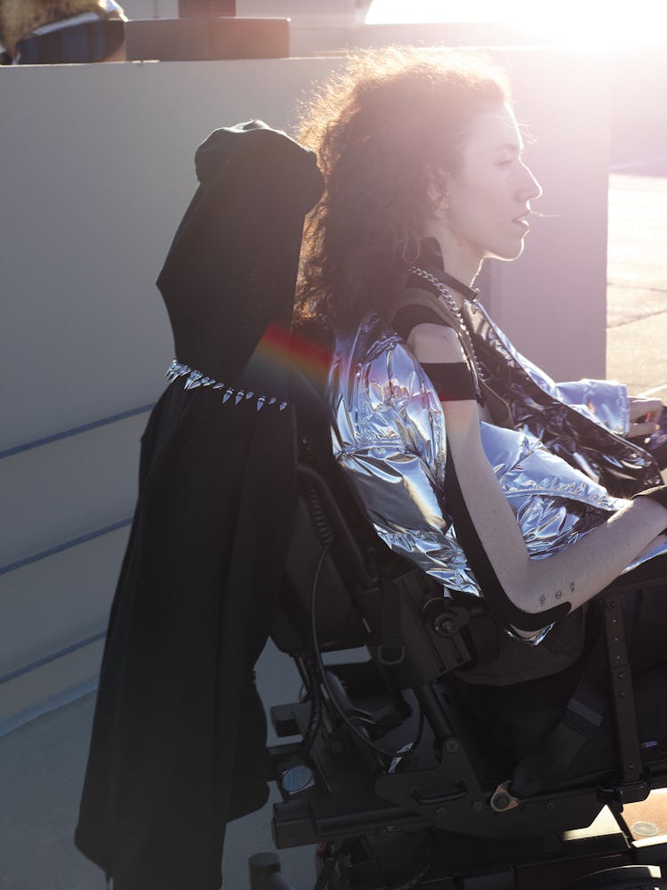 A woman in a silver metallic puffer jacket 