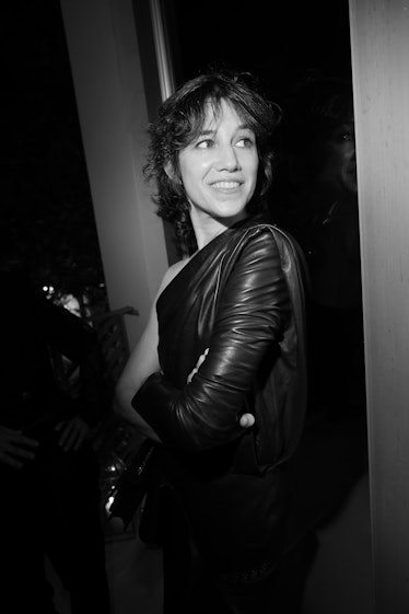 Charlotte Gainsbourg in a black asymmetric leather dress by Saint Laurent in a black-and-white photo