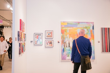 A visitor admiring artworks at Art Basel Miami Beach 2016.
