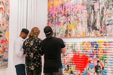 Guests looking at paintings at the Art Basel Miami Beach 2016