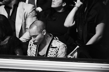 Olivier Rousteing sitting front row at the Victoria's Secret Fashion Show 2016 and looking down