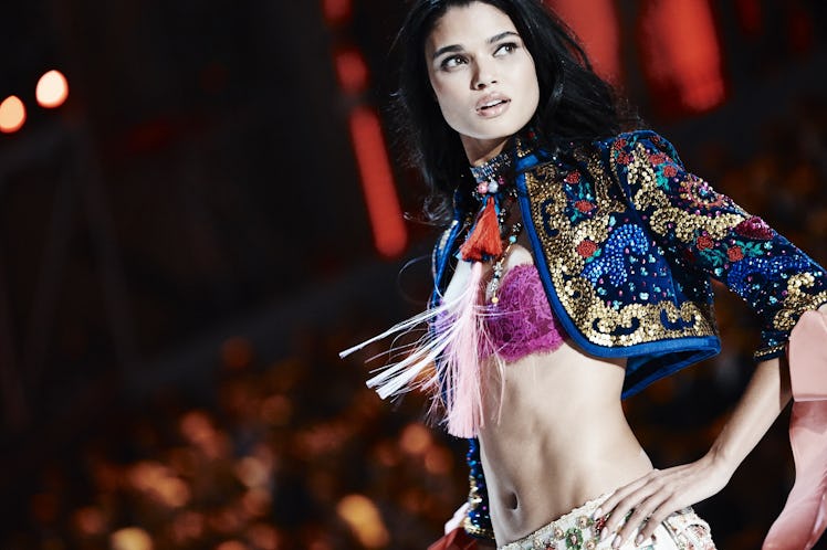 A model in a purple bra and a blue crop jacket with embroidery at the 2016 Victoria’s Secret Fashion...