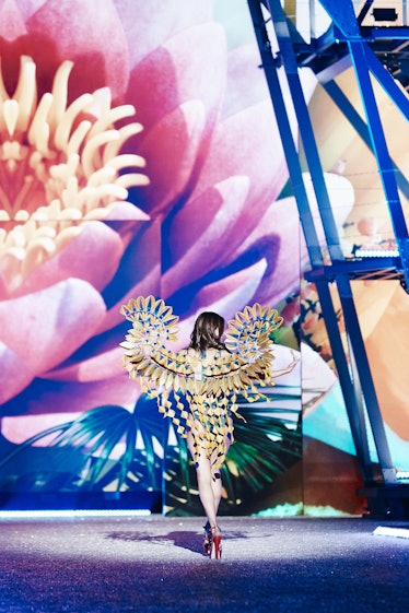 The back of a model with large yellow geometric-wing element on her back at the 2016 Victoria’s Secr...