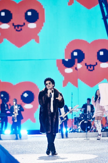 Bruno Mars in a brown coat and a white shirt performing at the 2016 Victoria’s Secret Fashion Show 