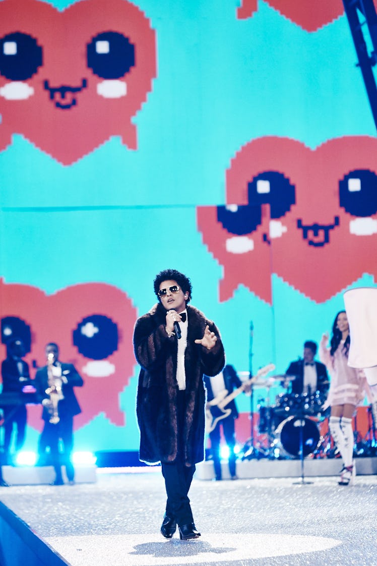 Bruno Mars in a brown coat and a white shirt performing at the 2016 Victoria’s Secret Fashion Show 