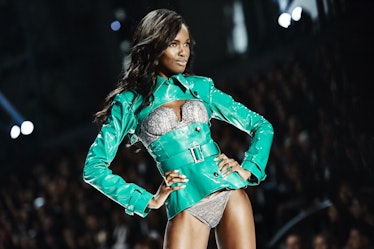A model posing in grey lingerie and a green jacket at the 2016 Victoria’s Secret Fashion Show 