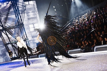 Lady Gaga performing while Joan Smalls is walking with large black wings at the 2016 Victoria’s Secr...