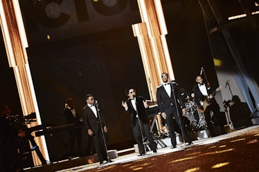 Four men in black tuxedos and white shirts performing at the 2016 Victoria’s Secret fashion show