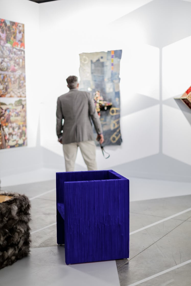 A visitor captivated by painting during the 2016 Art Basel Miami Beach event