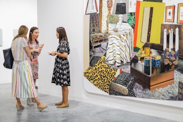 Three women in summer dresses, discussing artwork at Art Basel Miami Beach 2016.