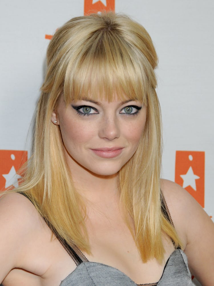 Emma Stone as a platinum blonde with a cat eye makeup look at The Trevor Project Annual Show in 2010