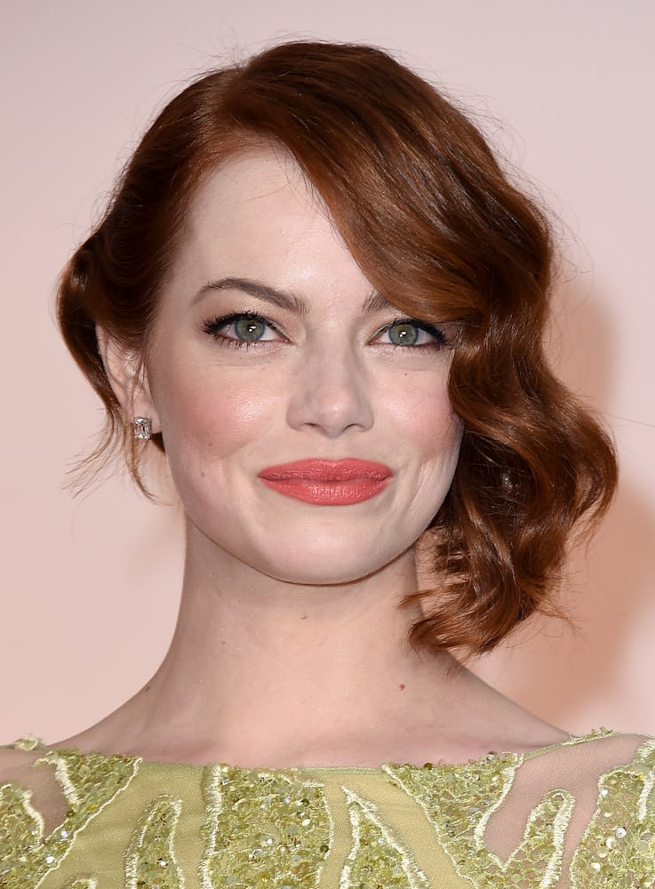 Emma Stone with her auburn locks softly tousled to the side, and a natural makeup look at the 87th A...
