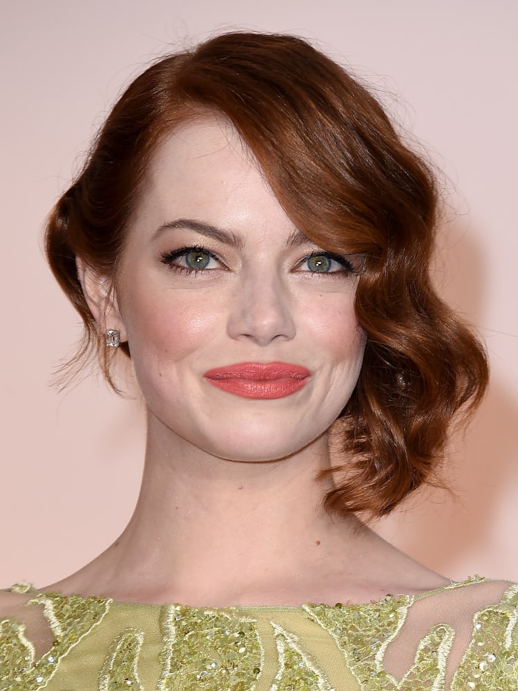 Emma Stone with her auburn locks softly tousled to the side, and a natural makeup look at the 87th A...