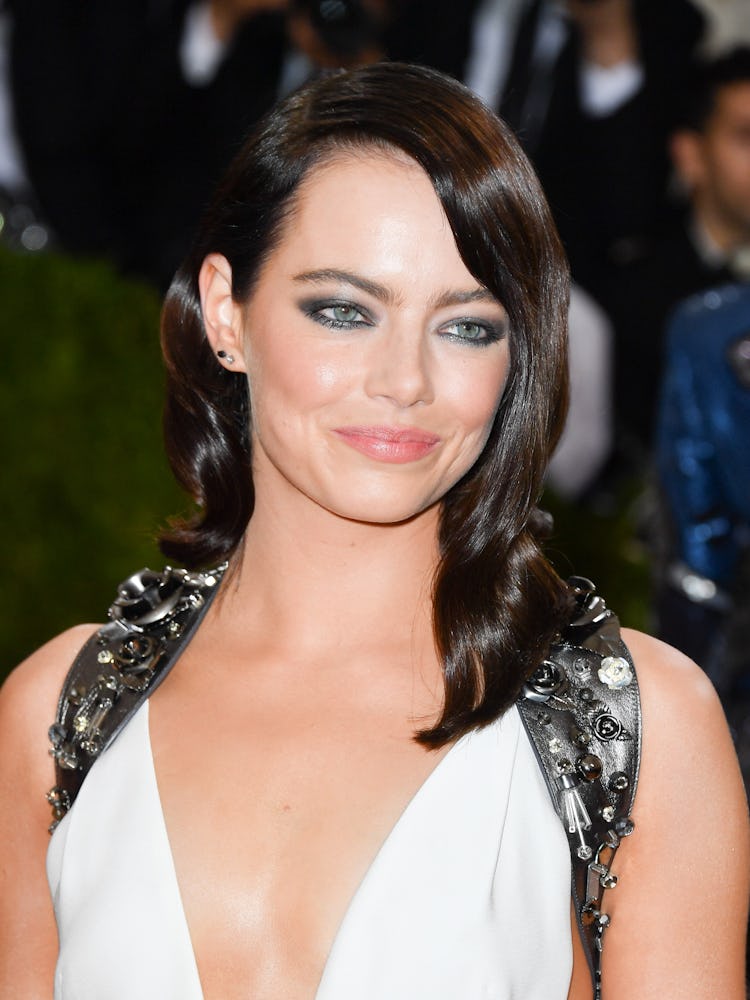 Emma Stone as a brunette, with a dramatic dark smoky eye and a nude lip at the 2016 Met Gala