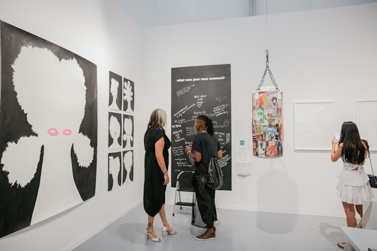 Visitors admiring artworks at Art Basel Miami Beach 2016.
