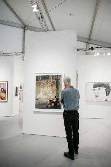 A guest marveling at painting during the 2016 Art Basel Miami Beach event.