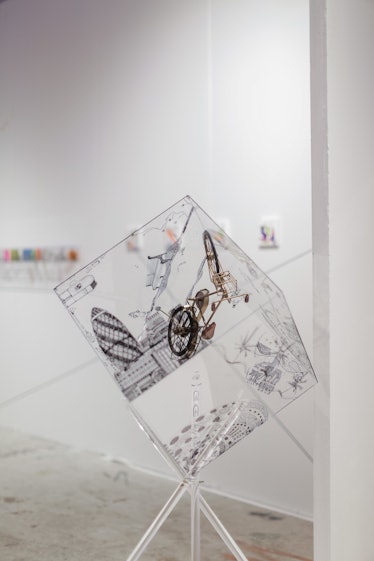 A transparent cube with graphic illustrations on each side at Art Basel Miami Beach 2016.