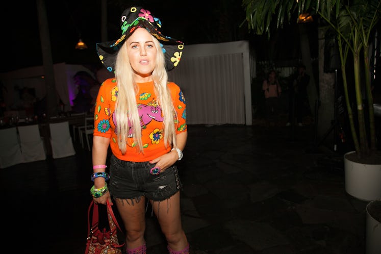 A guest wearing a floral print hat at Moschino Miami party