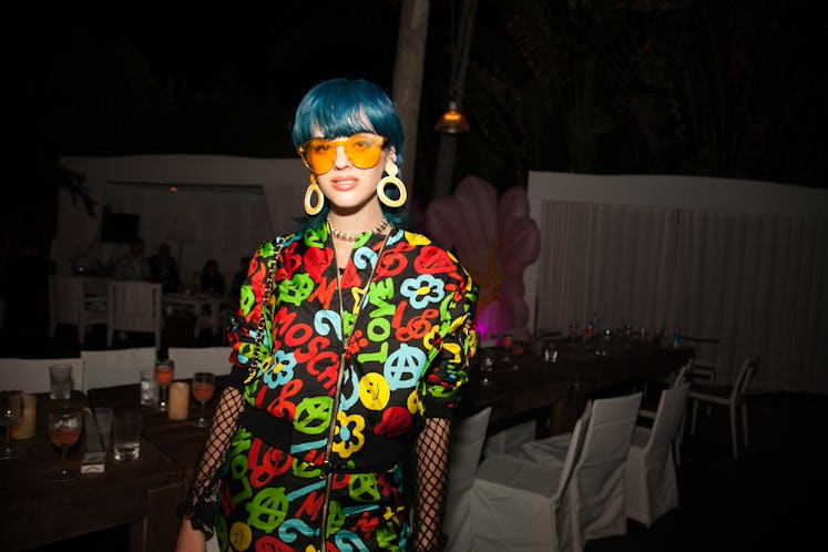 A guest posing for a photo during Moschino Miami party